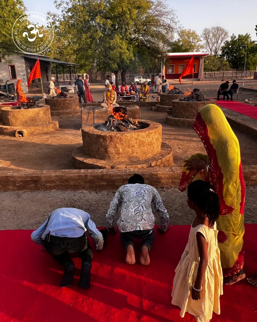 Devotees performing parikrama and bowing to the dhunies at Panch Dhuni Tapasya in OM Ashram.